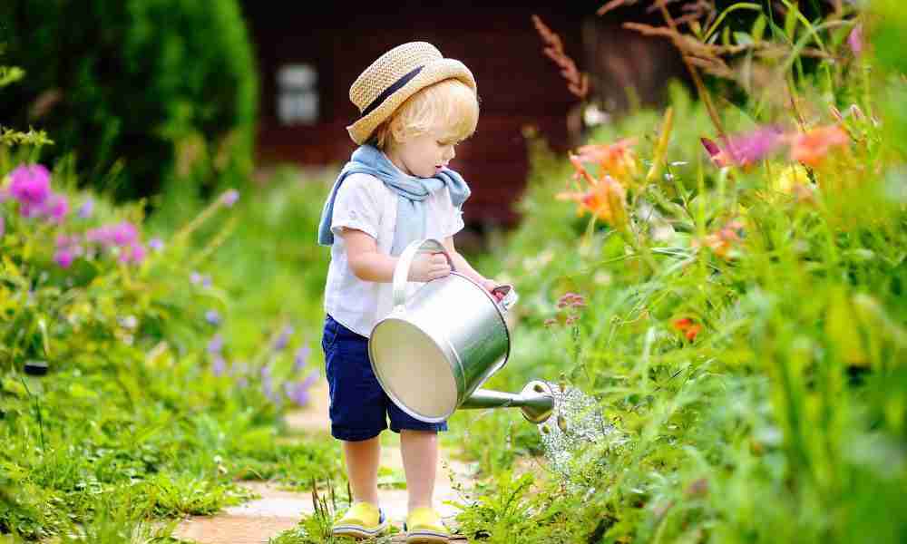 Gardening with Children Plymouth - Kid with Wtering Can - Jackson Landscaping Ltd
